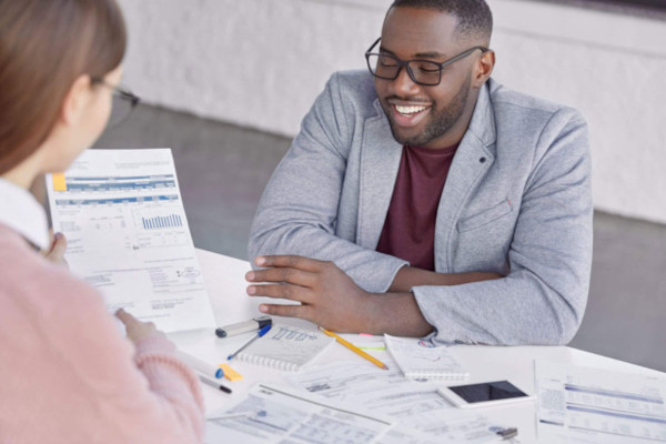 Man working on paperwork with customer